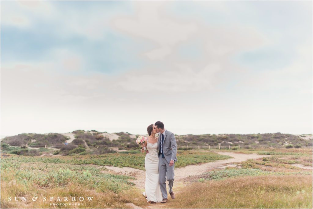 A Bride and Groom kiss at their destination wedding at Mandalay Beach Resort