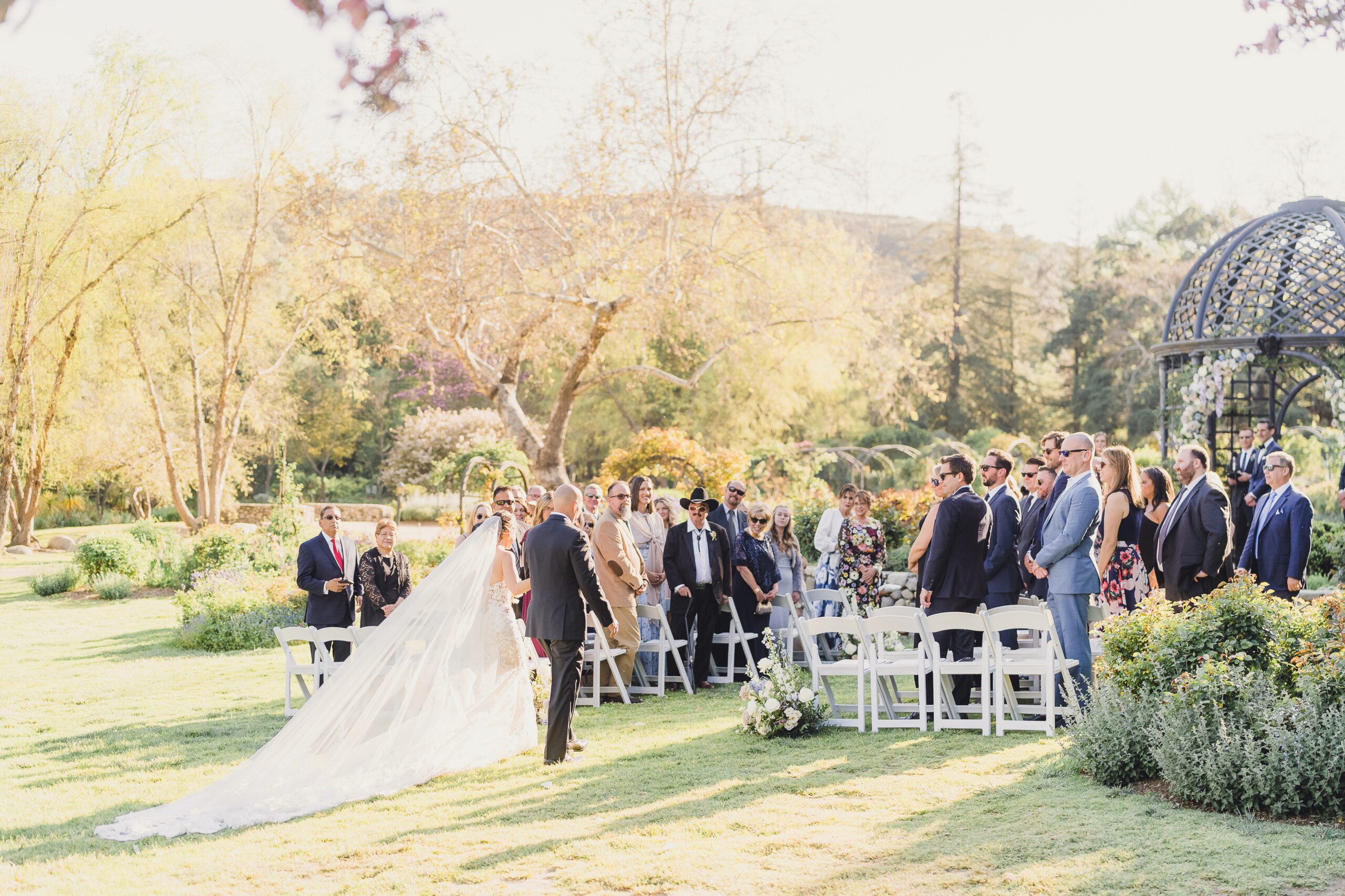 A bride and groom walk down the aisle at their Lavender Descanso Gardens Wedding