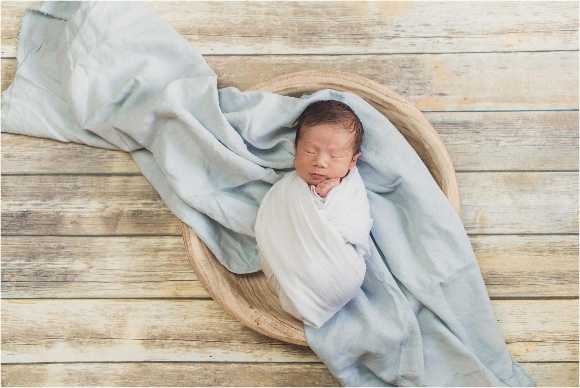 little oliver in a basket with a blue blanket photographed by marina del rey newborn photograper, sun & sparrow