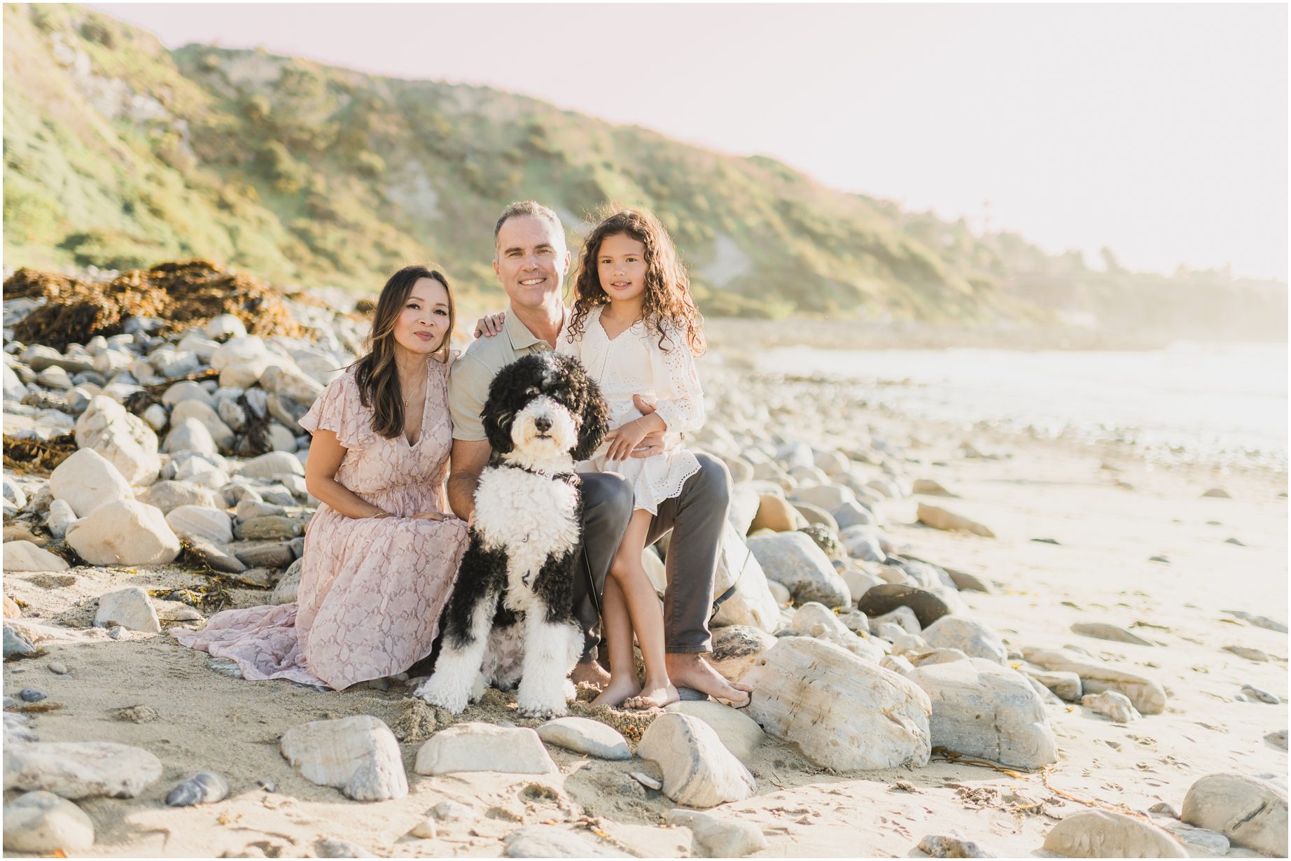 A family with a dog poses for sunset photos during their Holiday Mini Session