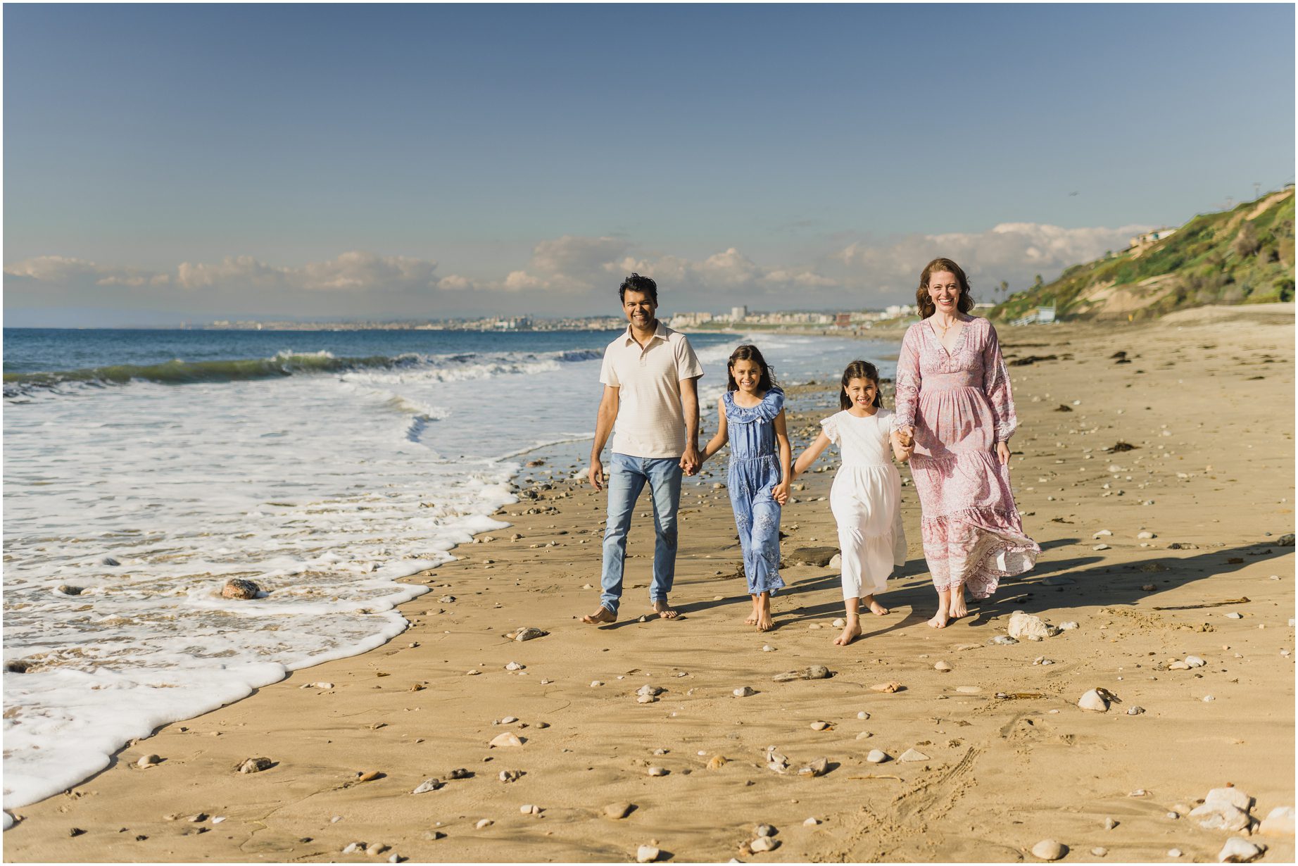 A family walks along the Beach in Redondo during their Los Angeles Mini Sessions
