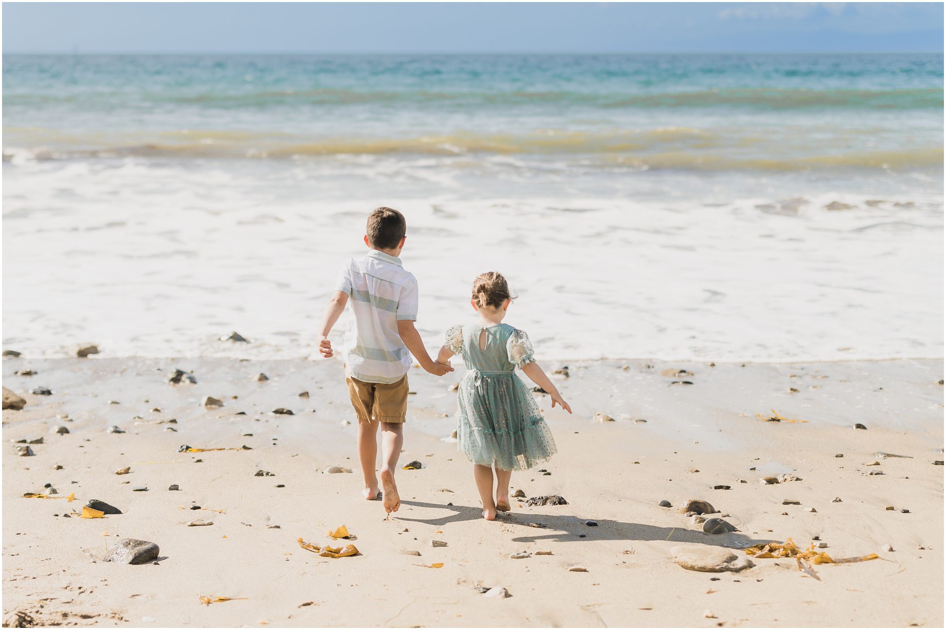 A boy and his sister walk at the beach in Palos Verdes