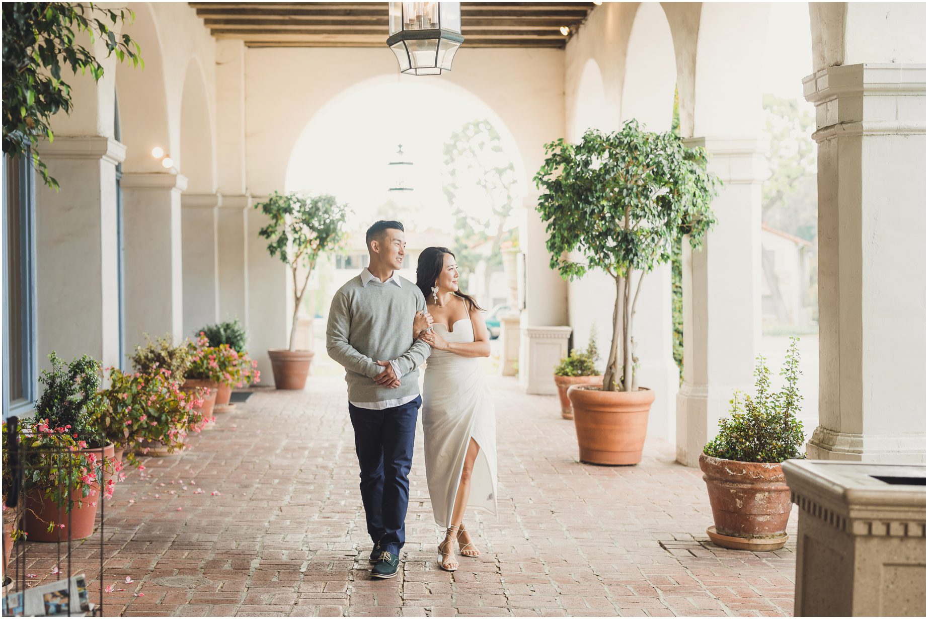 A couple walks through the veranda at Malaga Cove Plaza during their Malaga Cove Plaza Mini Session