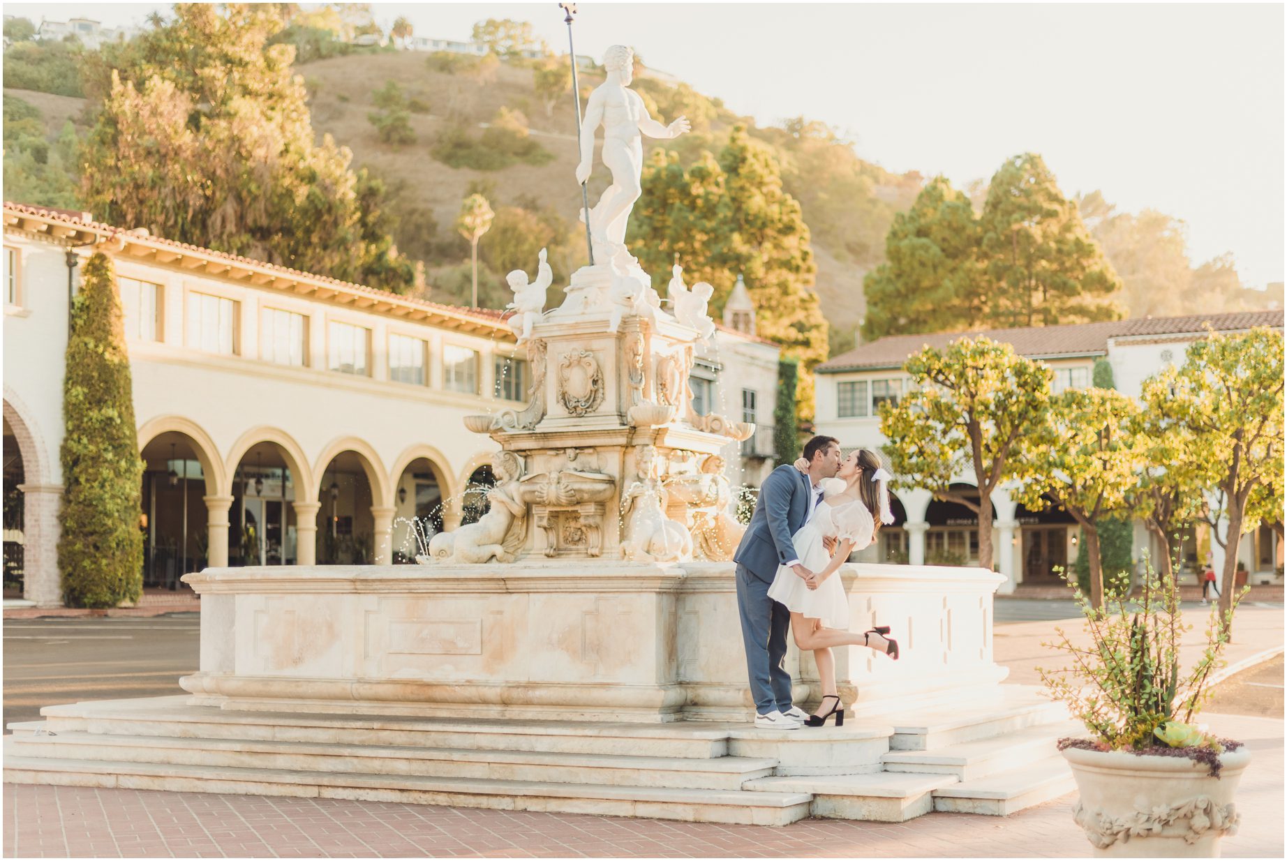 A couple poses at the Fountain at Malaga Cove Plaza in Palos Verdes