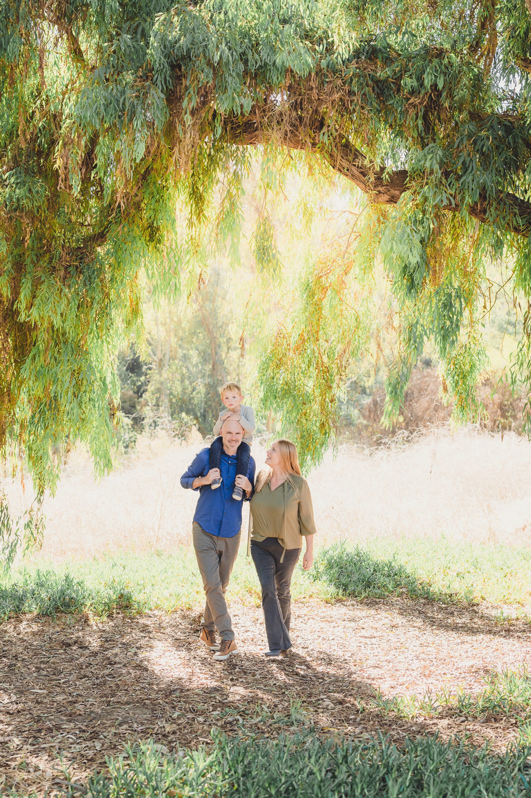 A family walks through the secret field during their holiday mini session