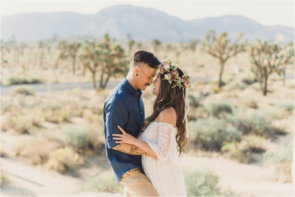 A couple hold each other during their joshua tree engagement session