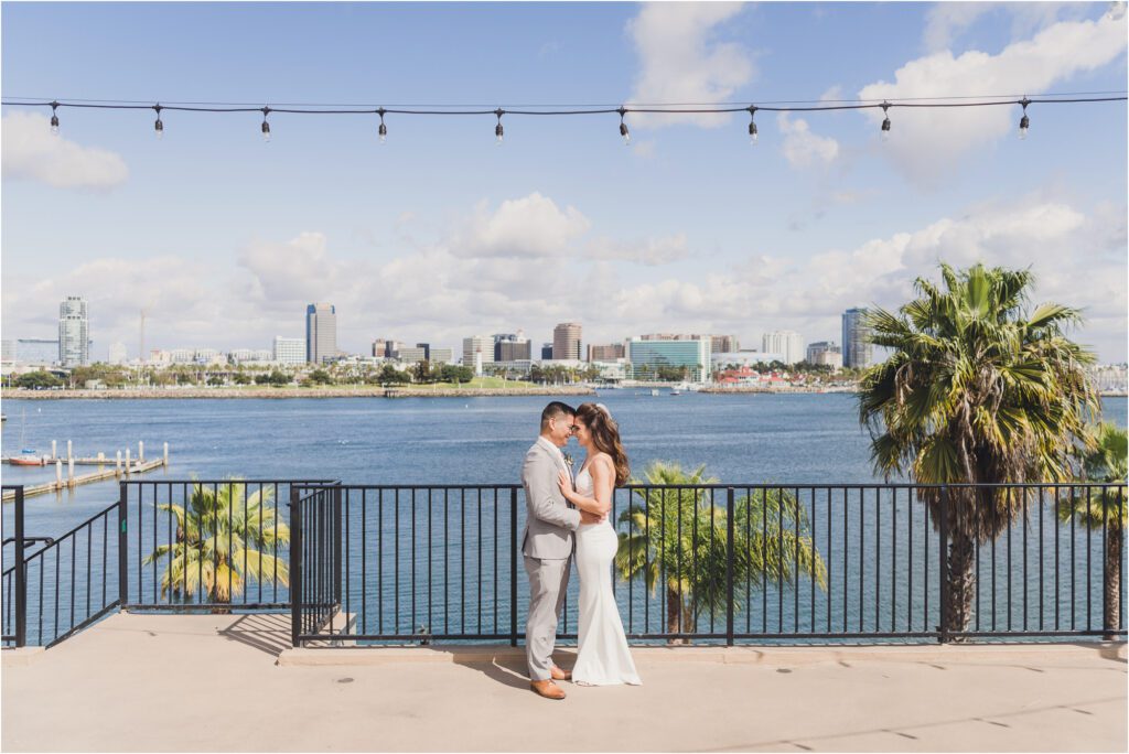 A Bride and Groom kiss at their wedding in Long Beach. Sun and Sparrow took their picture and is a  Long Beach Wedding Photographer