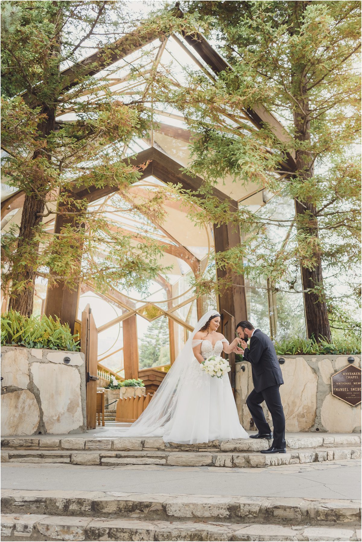 A Bride and Groom take a picture in front of Wayfarer's Chapel in Palos Verdes