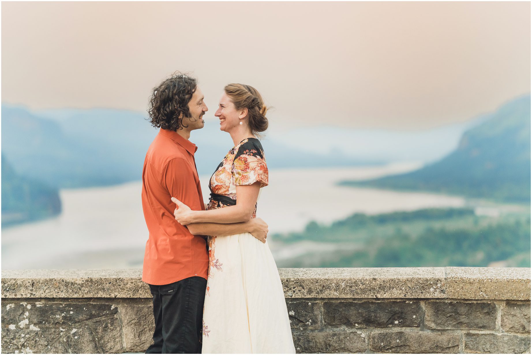 a couple shares an embrace over the Columbia river gorge