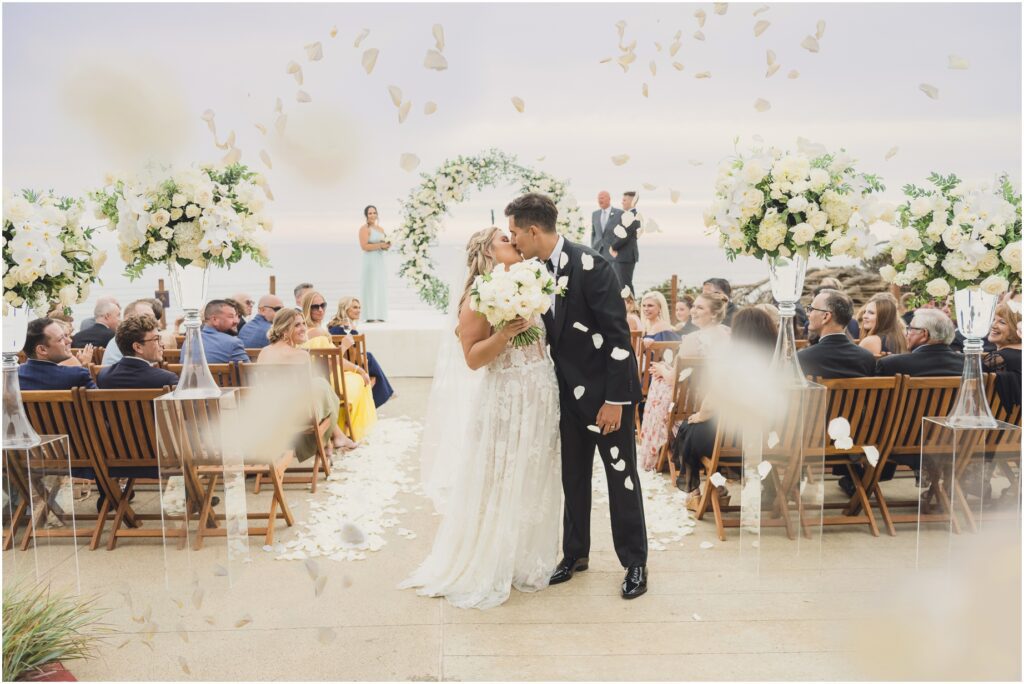 A Bride and Groom Kiss before they walk down the aisle at their all area beach resort wedding
