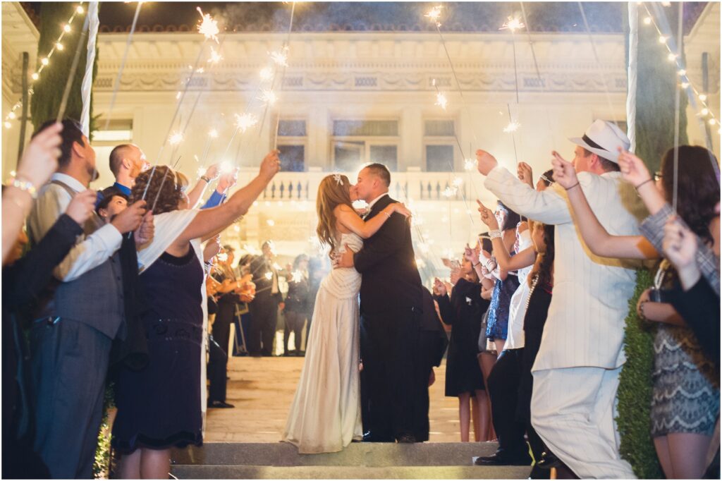 A bride and groom kiss during their Great Gatsby inspired wedding at Ambassador Gardens in Pasadena