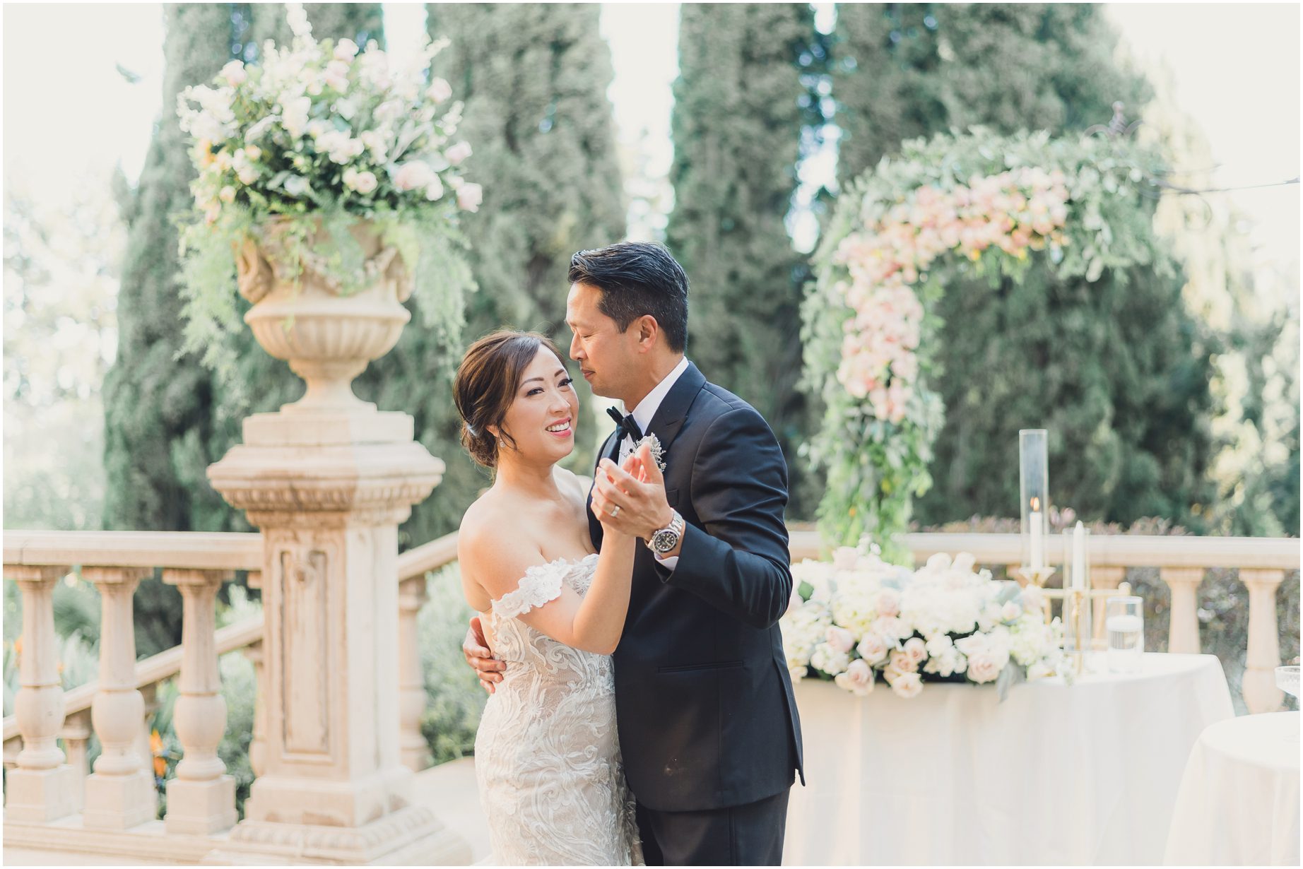 A couple shares a dreamy first dance next to their sweetheart table at Villa del sol d'Oro in Sierra madre