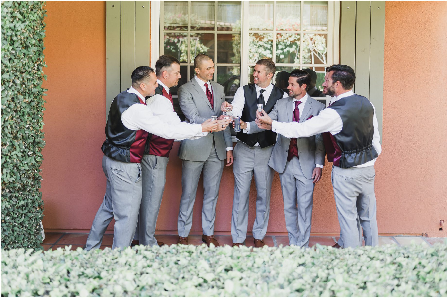 A groom and his groomsmen share a drink on the patio before a Malibu west beach club wedding