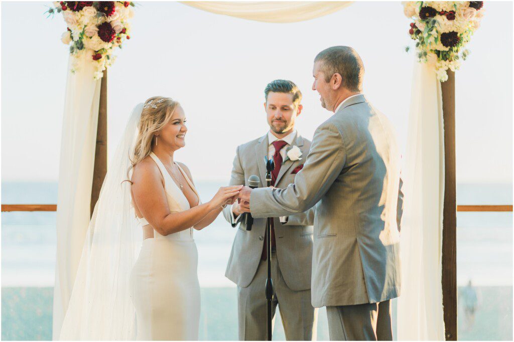 A bride and groom exchange vows at their Malibu wedding