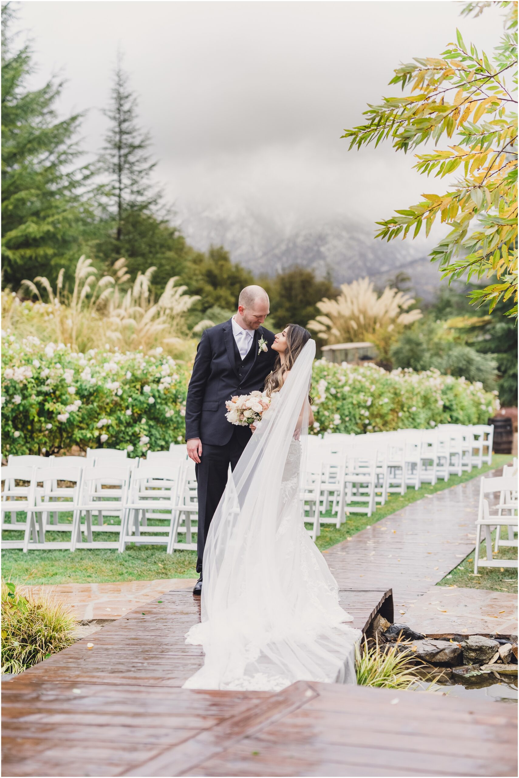 A bride and groom lean into each other at their serendipity gardens wedding