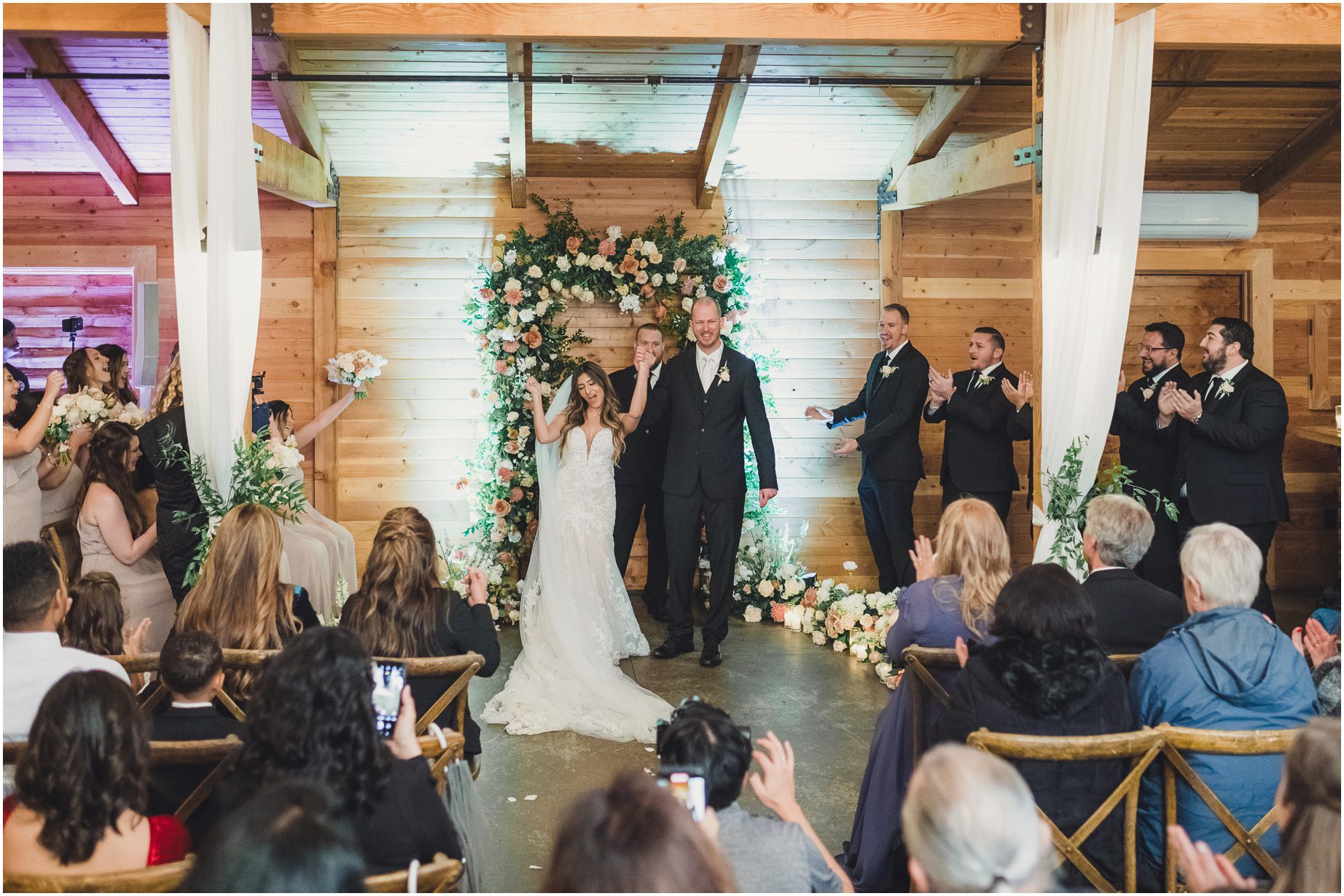 A bride and groom get married inside the barn at Serendipity Garden Weddings