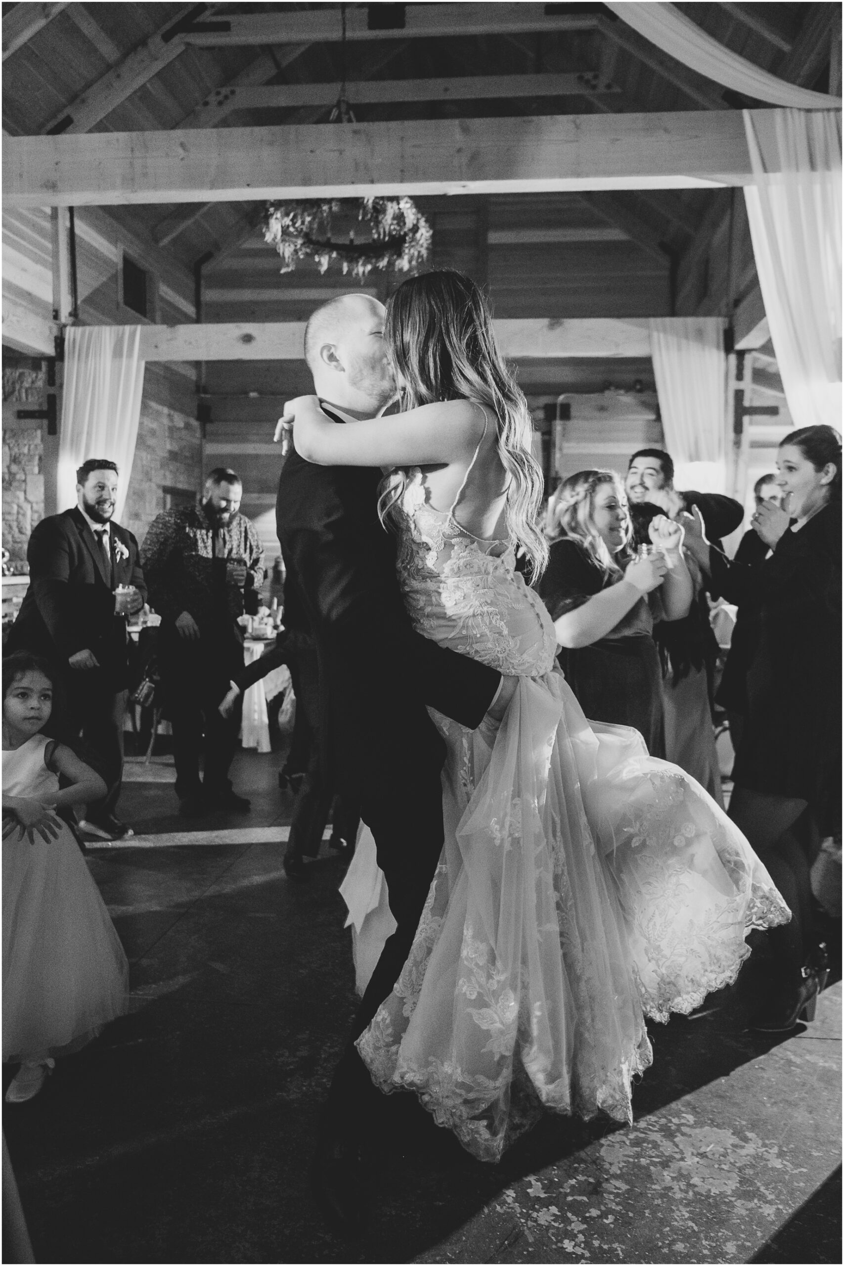 A groom lifts the bride during a dance at Serendipity Garden Weddings