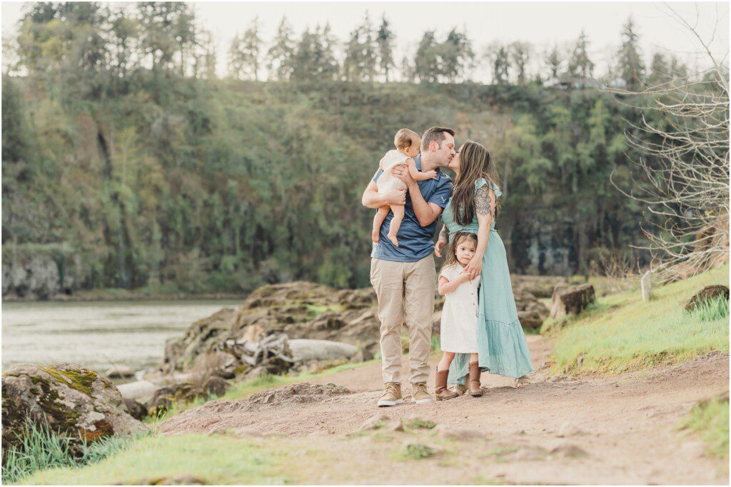 A family wearing blue and white poses for pictures at Elk Rock Island in lake Oswego