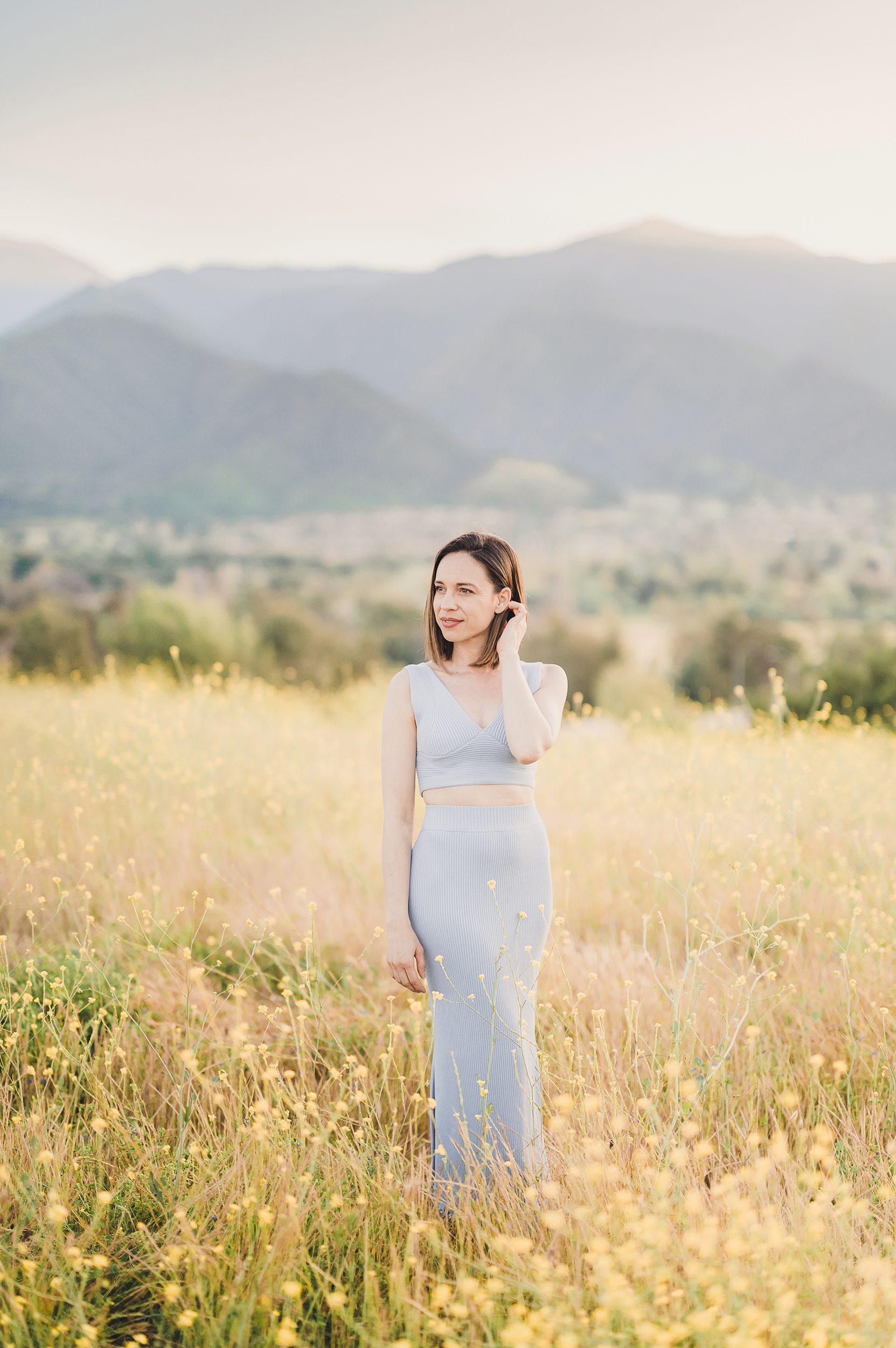 Ellie Fuqua, owner of Sun & Sparrow Photography, Stands in a field