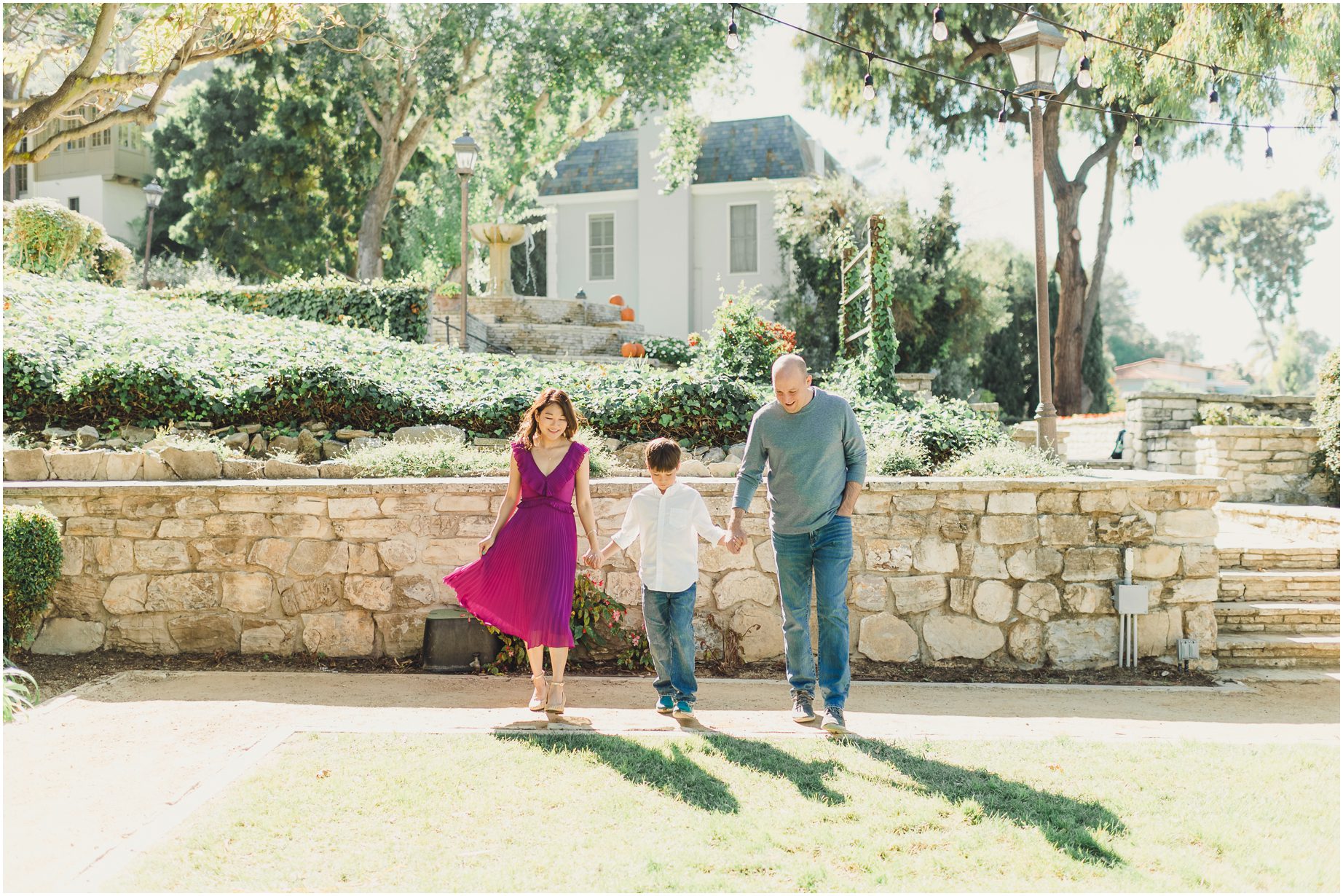 A family walks across a grassy area at Malaga Cove Library