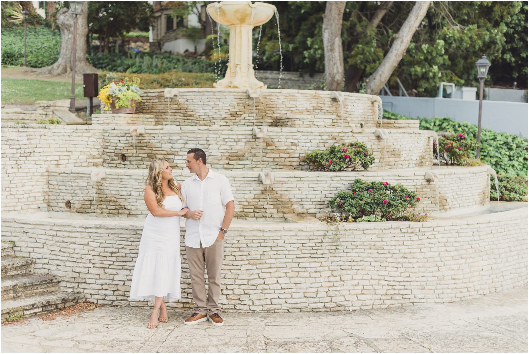 A couple poses in front of the water feature at Malaga Library in Palos Verdes