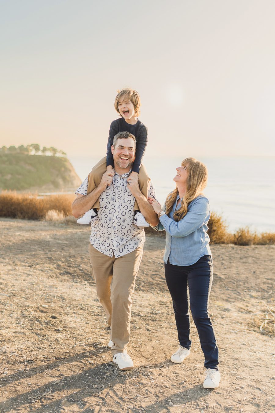 A family walks on the PALOS VERDES Cliffs during their family mini session with sun & sparrow