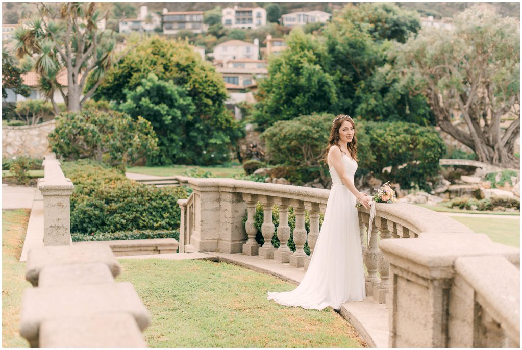 A bride looks over a balcony at the Neighborhood Church In Palos Verdes