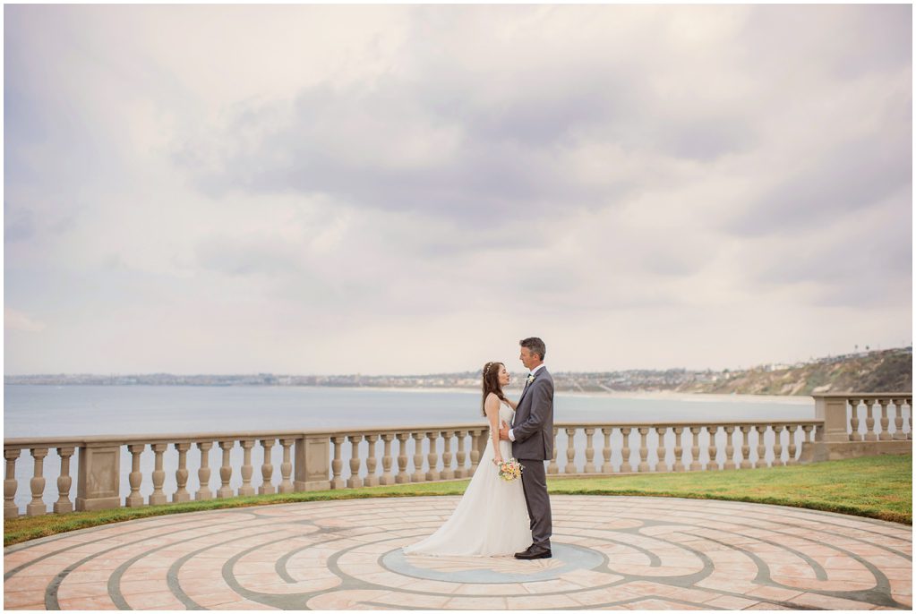 A bride and groom on a patio overlooking the Ocean at The neighborhood church in Palos Verdes Estates