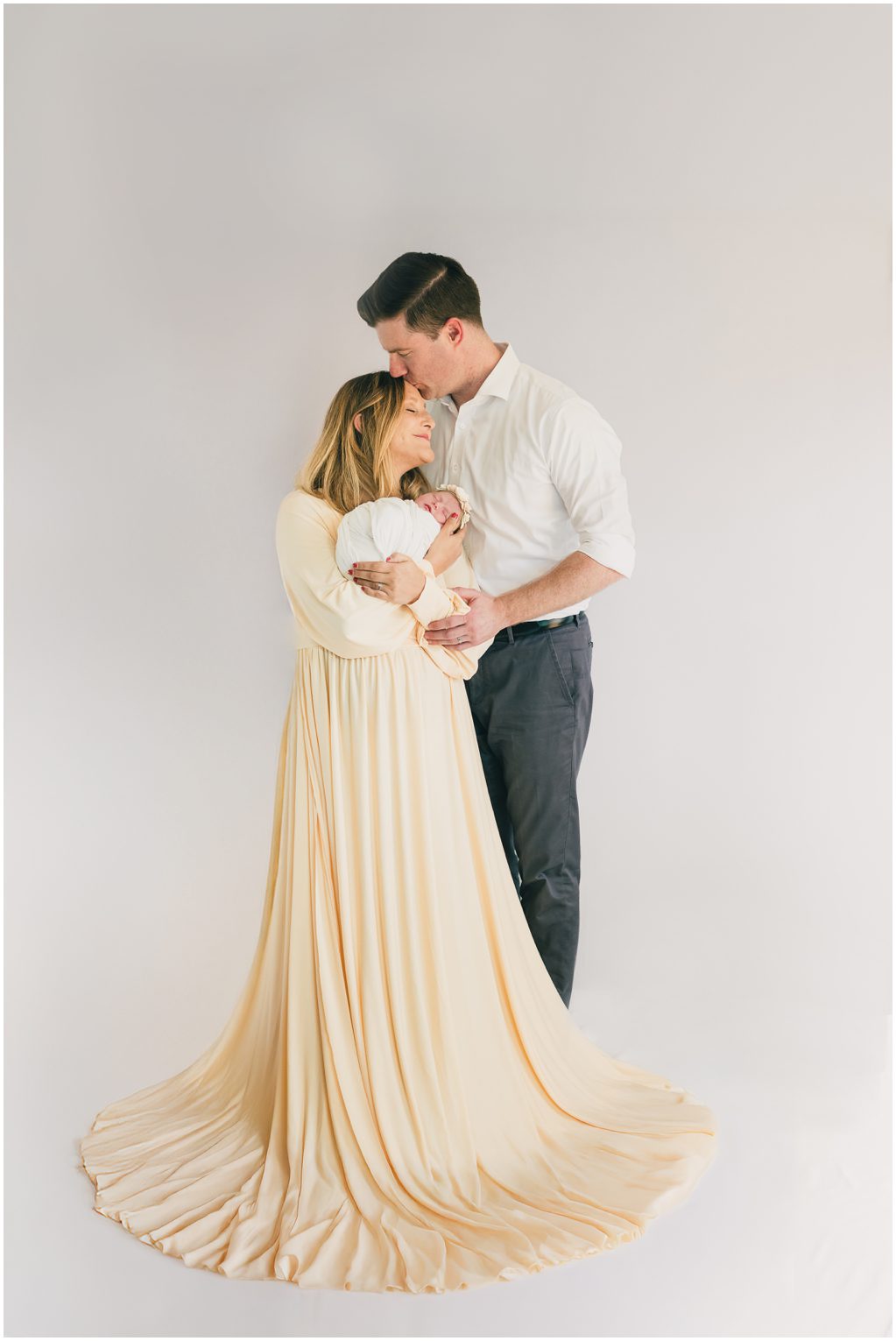 Parents pose with baby